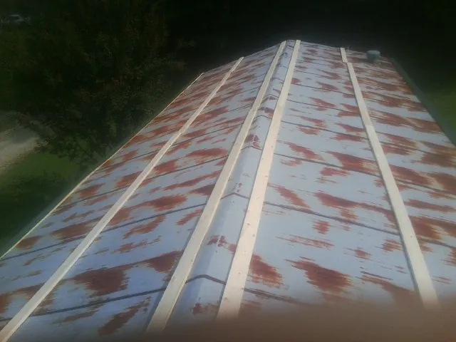 Rusted metal roof panels with new wood purlins before replacement — Storm Damage Roof Repair in Amston by Roofing Brothers